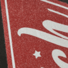 Close up picture of glitter dtf on red image.